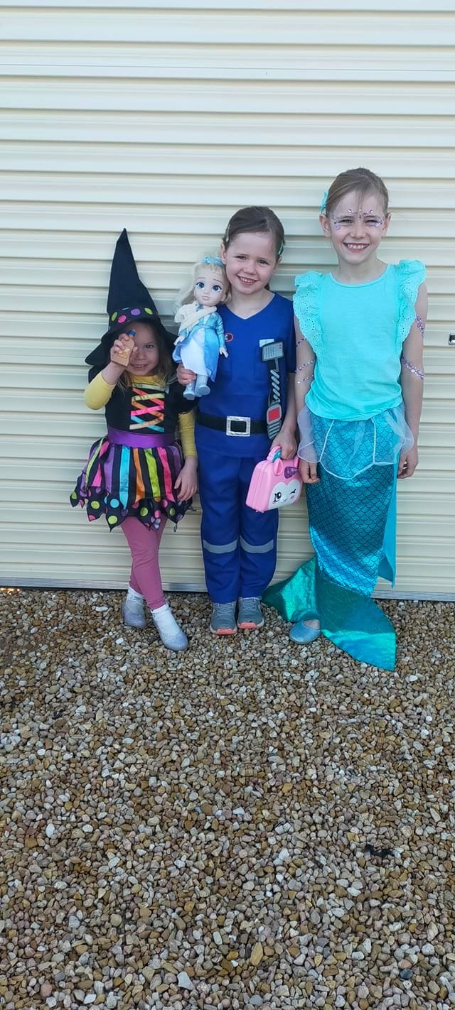 Renmark North School students and siblings Zara, 3, Evie, 6, and Indy Taylor, 9, as a witch, paramedic and mermaid.