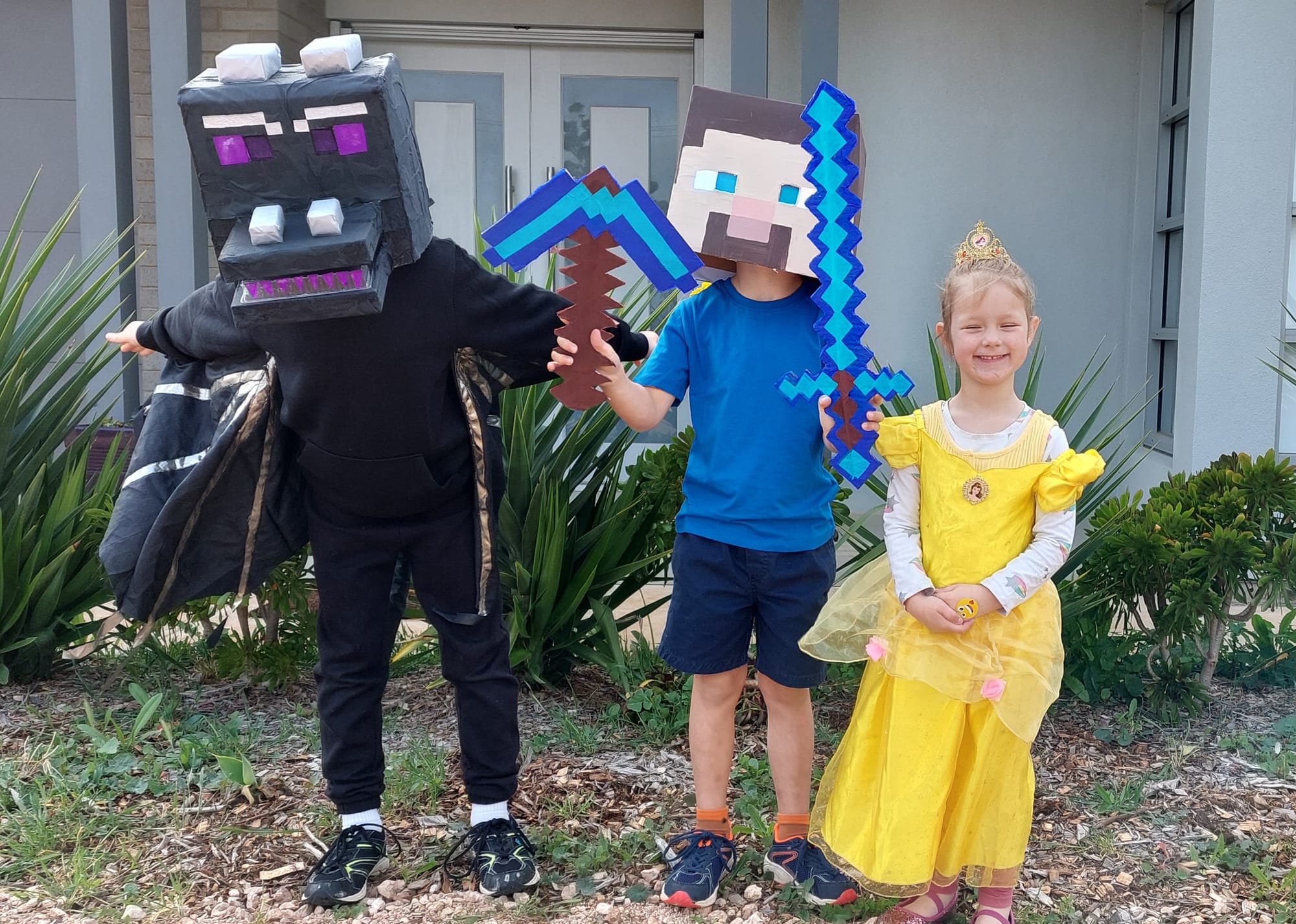 Renmark West Primary School students Lucas, 8, Alex, 7, and Emilia Philp, 4, as Minecraft Ender, Minecraft Steve and Belle.
