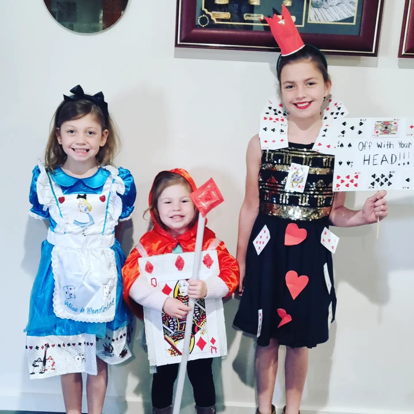 Renmark West Primary School students Nicola 7, Milla, 3, and Koa Tregeagle, 9, as Alice in Wonderland, The Cardsman and The Queen of Hearts.