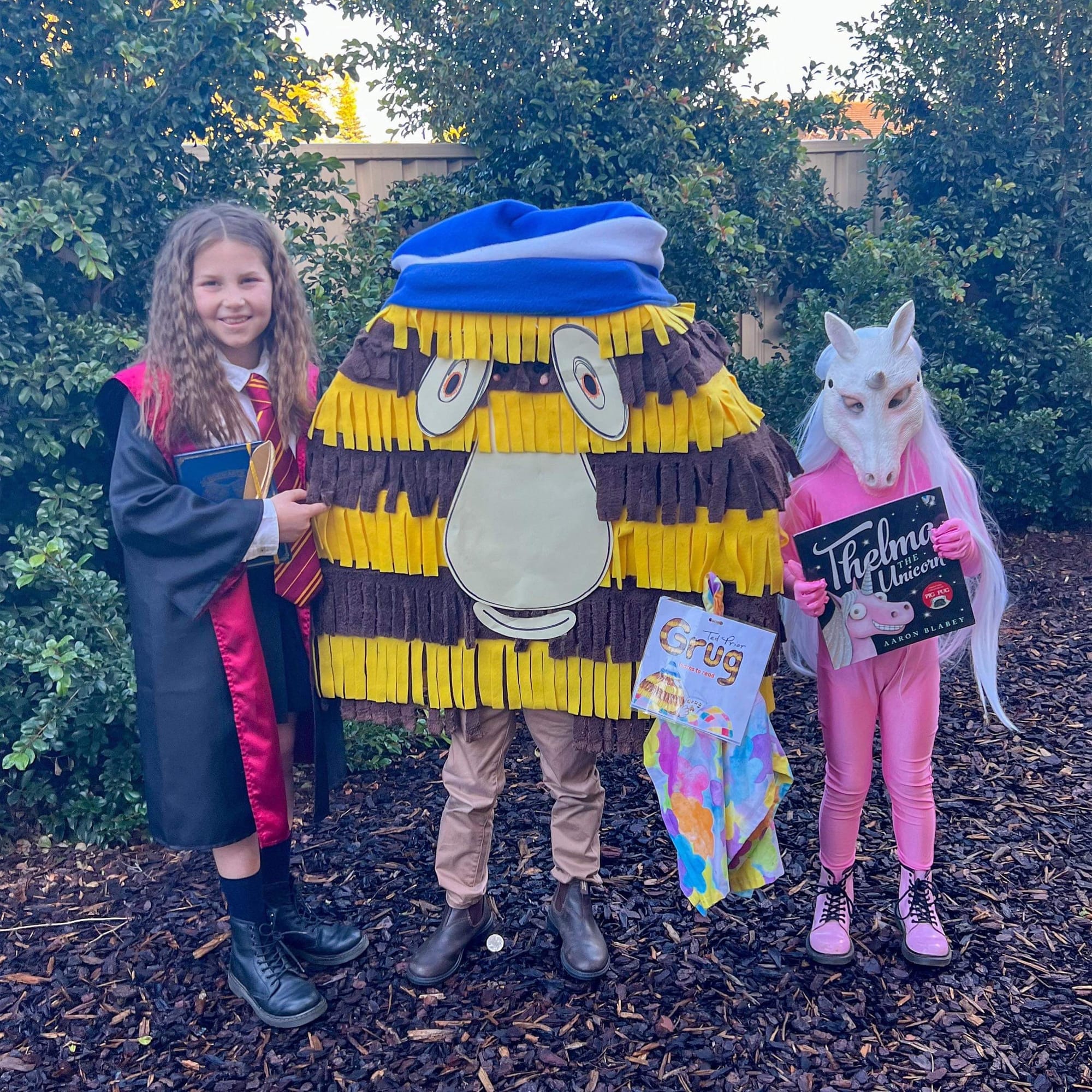 Loxton Lutheran School students and siblings Grace, 9, Hugo, 6, and Lucy Singh, 5, as Hermione, Grug and Thelma the Unicorn.